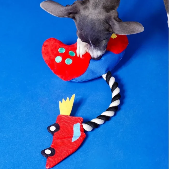 Interactive "Paw Controller" dog toy with chewable tug ropes and squeaky buttons for fetch and tug-of-war games.