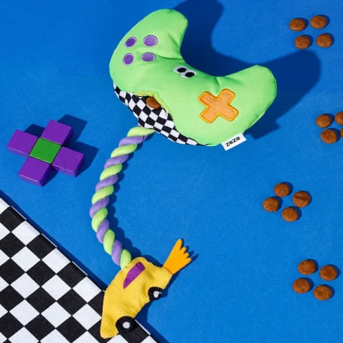 Interactive "Paw Controller" dog toy with chewable tug ropes and squeaky buttons for fetch and tug-of-war games.